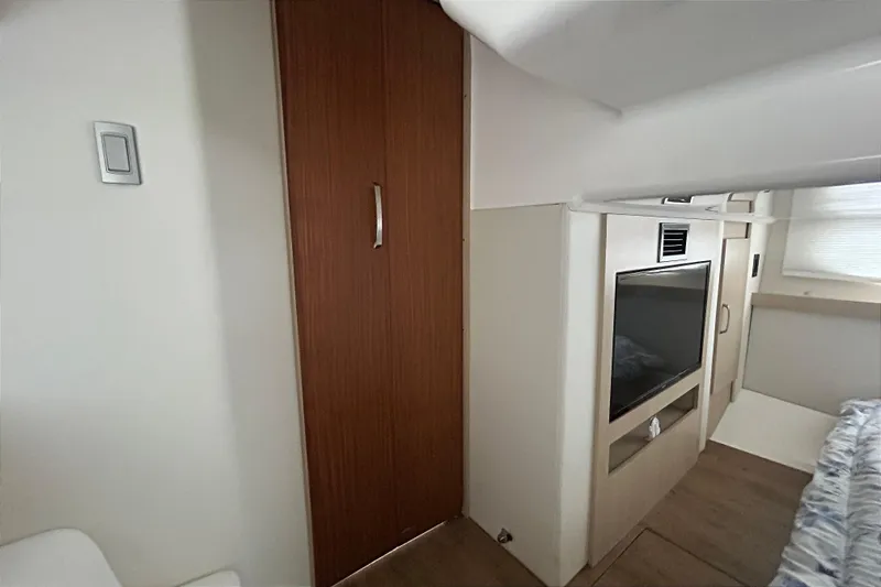 Slide: The Image of Interior of 2023 Regal 38 FXO yacht featuring modern wood paneling and a flat-screen TV. - 104