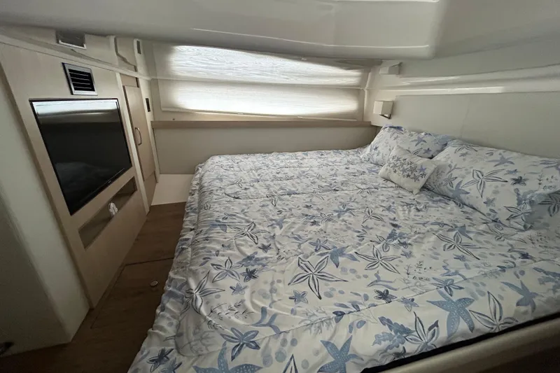 Slide: The Image of Luxurious cabin interior of 2023 Regal 38 FXO yacht with starfish-themed bedding. - 105