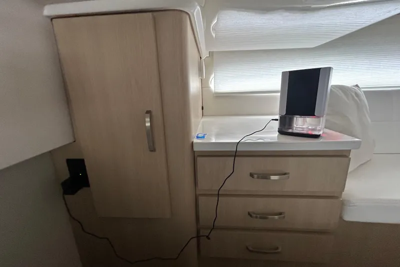 Slide: The Image of Interior of 2023 Regal 38 FXO yacht with modern cabinetry and electronic device. - 107