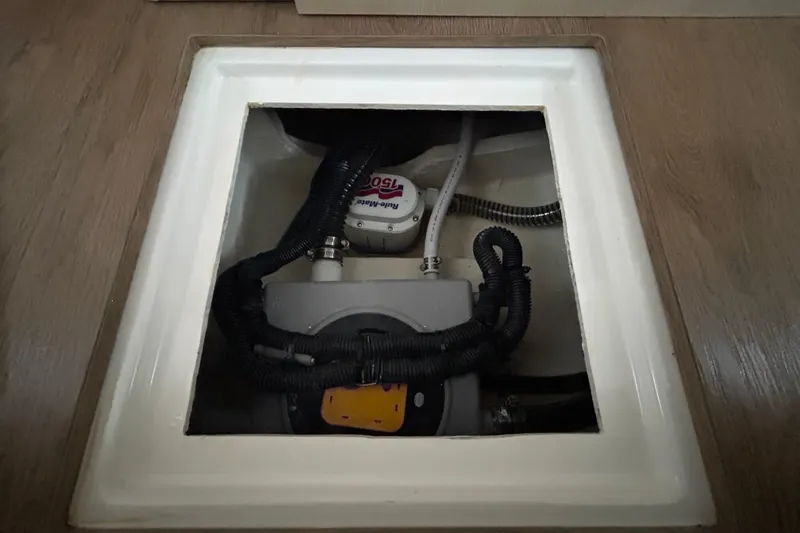 Slide: The Image of Bilge pump system in 2023 Regal 38 FXO boat, underfloor compartment view. - 111