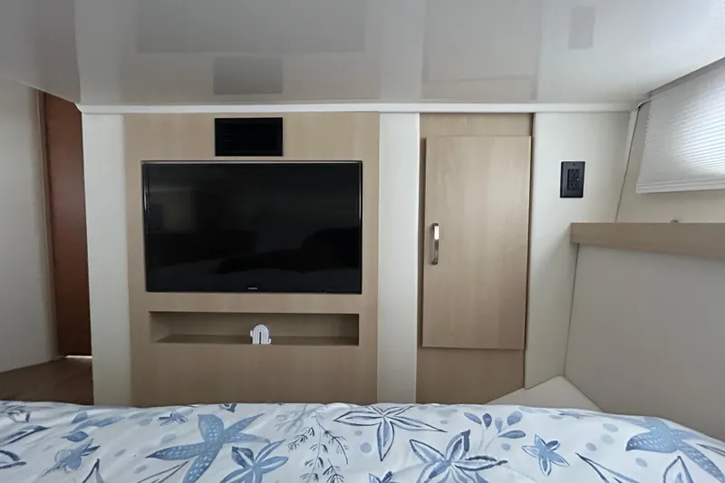 Slide: The Image of Interior of 2023 Regal 38 FXO yacht with TV and wooden cabinetry. - 112