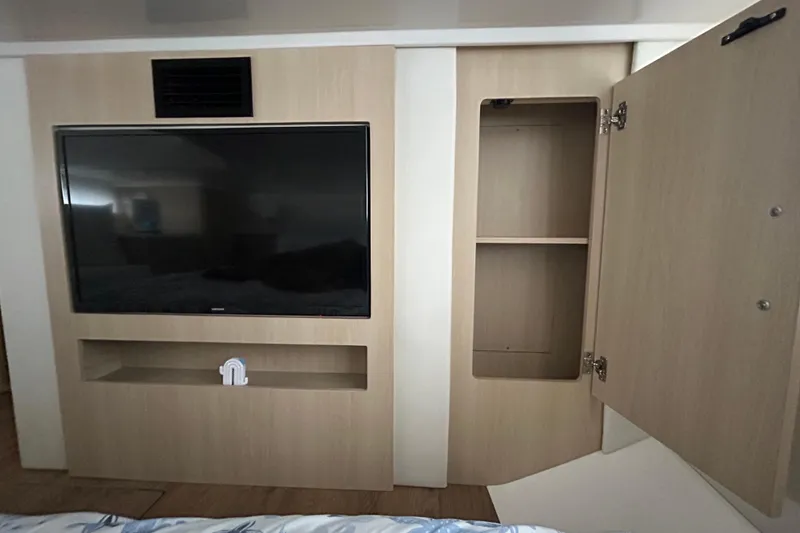 Slide: The Image of 2023 Regal 38 FXO interior with TV and open storage cabinet. - 113