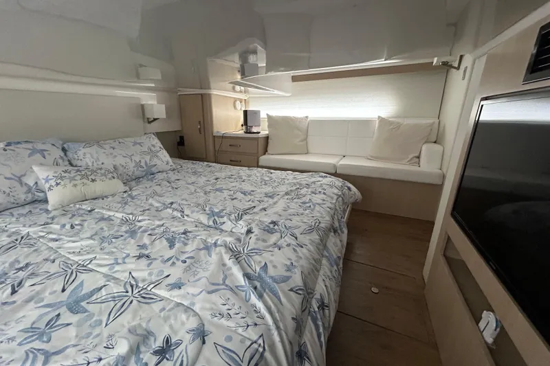 Slide: The Image of Luxurious cabin interior of 2023 Regal 38 FXO yacht with floral bedding and modern amenities. - 115