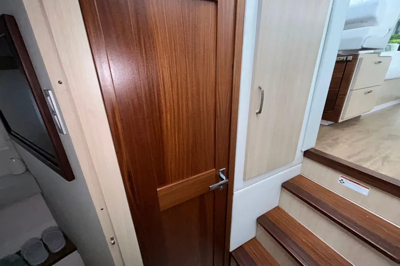 Slide: The Image of Interior of 2023 Regal 38 FXO yacht with wooden door and stairs. - 116