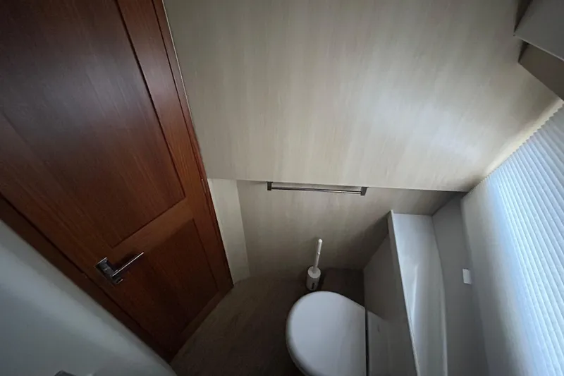 Slide: The Image of Compact bathroom interior of 2023 Regal 38 FXO yacht, featuring modern fixtures. - 118