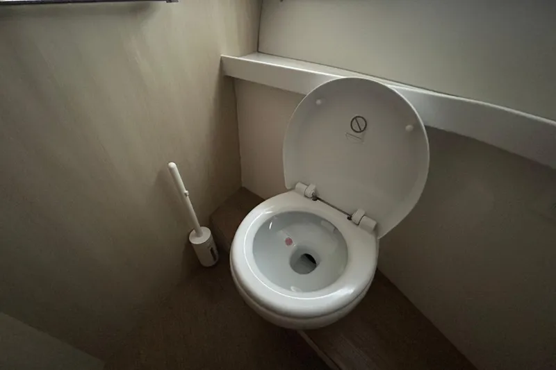 Slide: The Image of Modern bathroom on 2023 Regal 38 FXO yacht, featuring a sleek toilet design. - 119