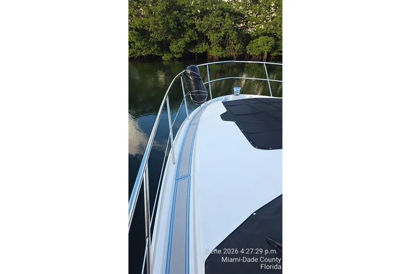 Slide: The Image of 2023 Regal 38 FXO boat on calm water in Miami-Dade County, Florida. - 12