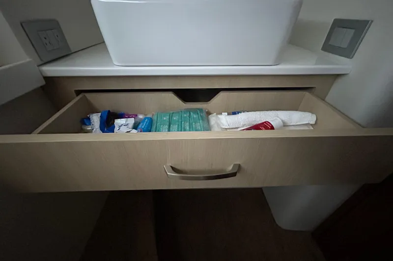 Slide: The Image of Open drawer with toiletries in a 2023 Regal 38 FXO boat bathroom. - 123
