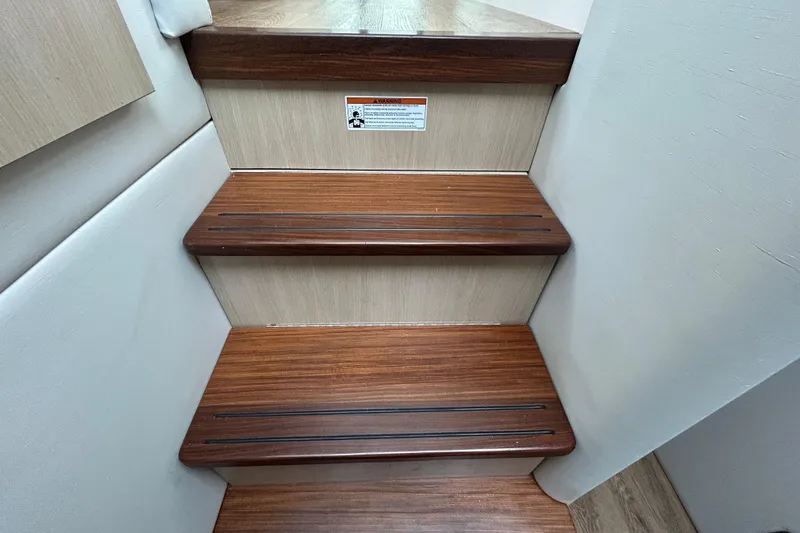 Slide: The Image of Wooden interior stairs of 2023 Regal 38 FXO boat, featuring sleek design. - 127