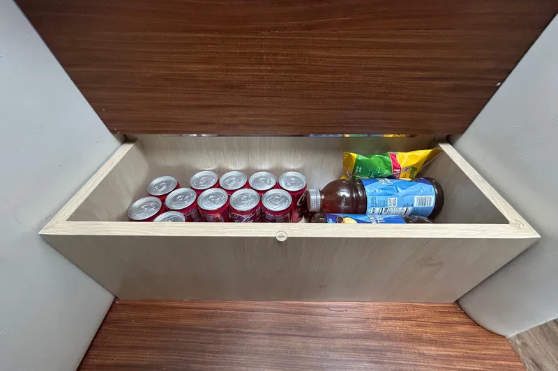 Slide: The Image of Storage compartment in 2023 Regal 38 FXO boat with drinks and snacks. - 128