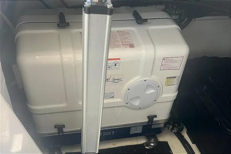 Slide: The Image of 2023 Regal 38 FXO engine compartment with generator and mechanical components. - 131