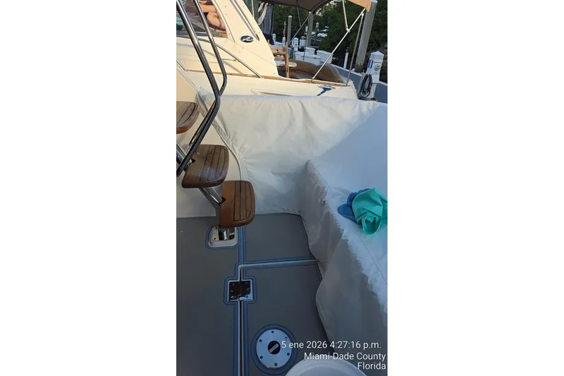 Slide: The Image of 2023 Regal 38 FXO boat docked, with hoses and equipment visible on deck. - 14