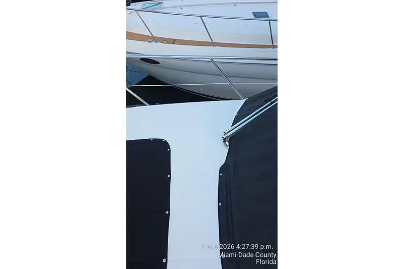 Slide: The Image of 2023 Regal 38 FXO yacht docked in Aventura, Florida, surrounded by lush greenery. - 18