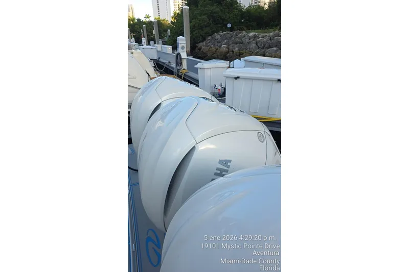 Slide: The Image of 2023 Regal 38 FXO yacht docked under bright sun. - 26