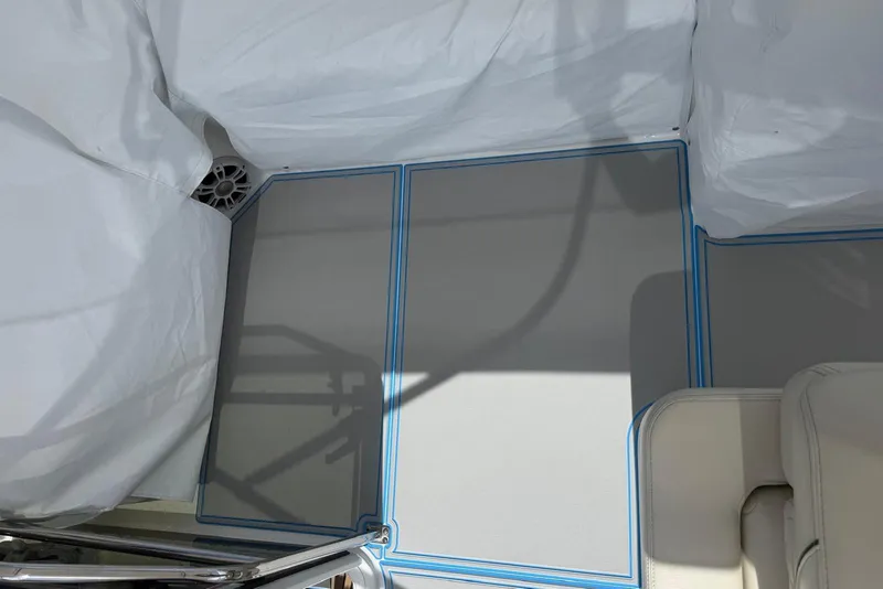 Slide: The Image of 2023 Regal 38 FXO boat stern with blue accents and docked fender. - 30