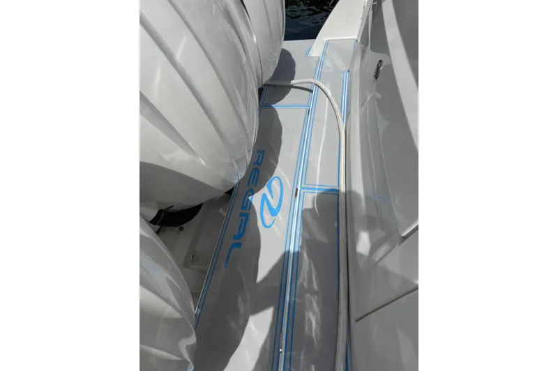 Slide: The Image of 2023 Regal 38 FXO boat interior with sleek flooring and wooden steps. - 38