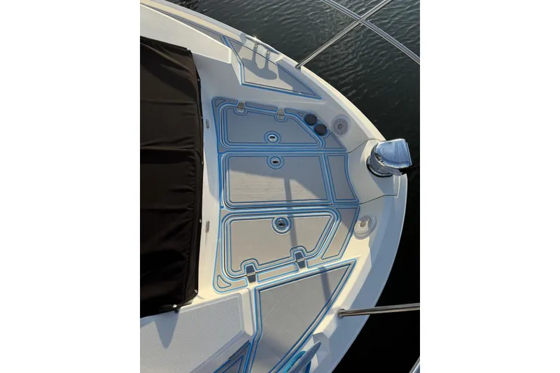 Slide: The Image of 2023 Regal 38 FXO boat docked, showcasing sleek design and railing details. - 45