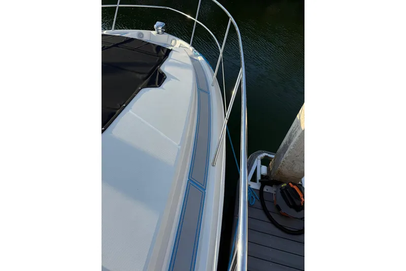 Slide: The Image of 2023 Regal 38 FXO boat deck with sleek design and stainless steel railing. - 47