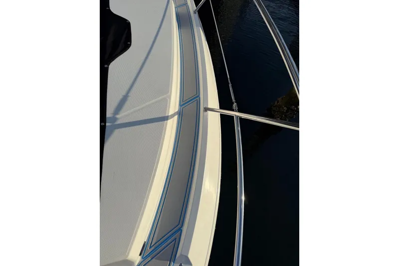 Slide: The Image of 2023 Regal 38 FXO yacht side view, docked on calm water. - 49