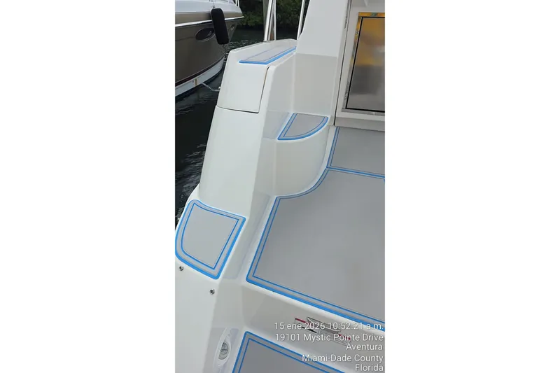 Slide: The Image of 2023 Regal 38 FXO boat deck with blue accents, docked in Aventura, Florida. - 64