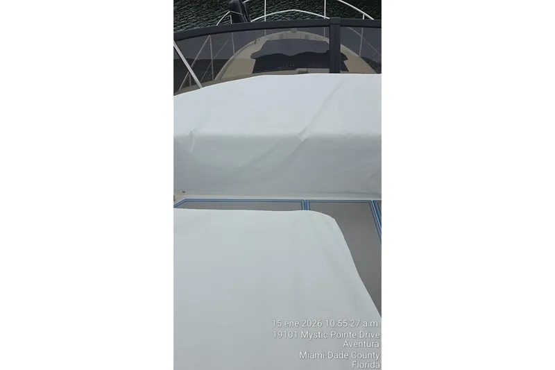 Slide: The Image of 2023 Regal 38 FXO yacht deck with white covers, docked in Aventura, Florida. - 67