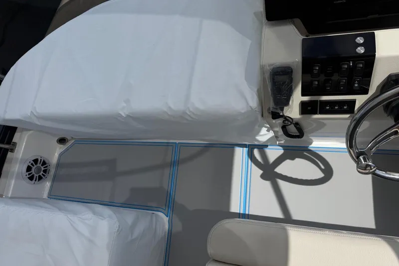Slide: The Image of 2023 Regal 38 FXO boat cockpit with steering wheel and control panel. - 7
