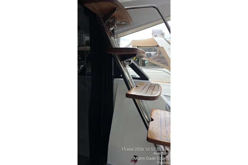 Slide: The Image of Staircase on 2023 Regal 38 FXO yacht, featuring wooden steps and sleek design. - 72