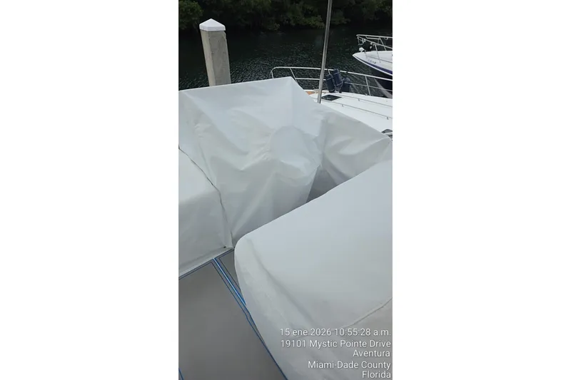 Slide: The Image of Covered seating area on a 2023 Regal 38 FXO boat docked in Miami. - 77