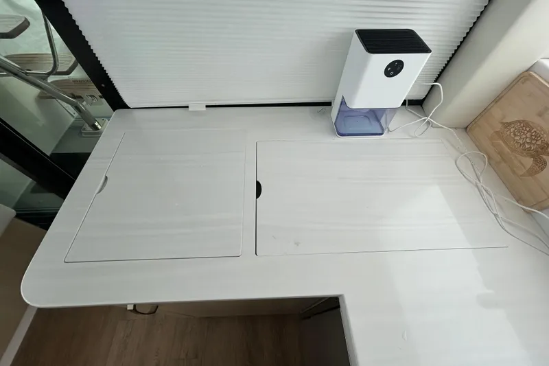 Slide: The Image of Modern kitchen counter on 2023 Regal 38 FXO yacht with appliance and cutting board. - 85