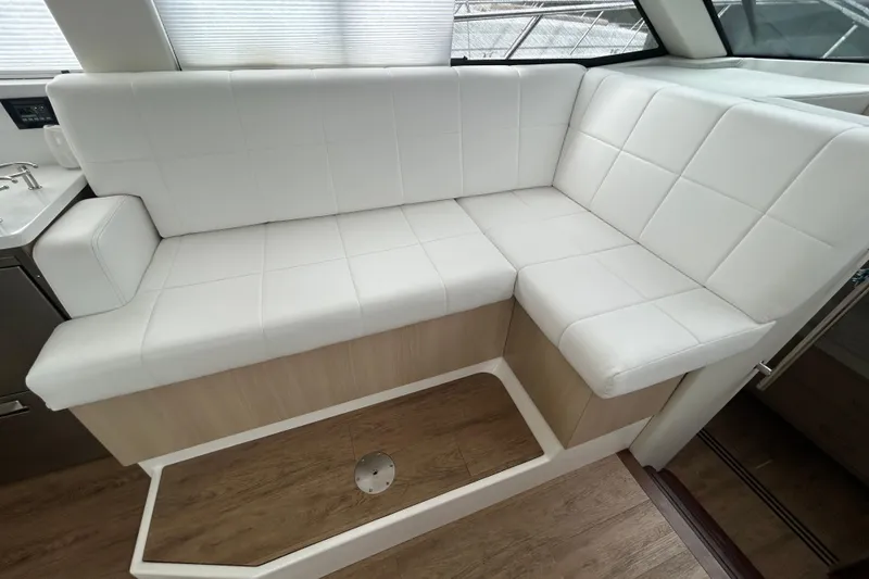 Slide: The Image of Luxurious white seating area inside 2023 Regal 38 FXO yacht, featuring modern design. - 89