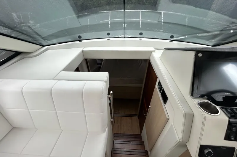 Slide: The Image of 2023 Regal 38 FXO yacht interior with white seating and modern dashboard. - 91