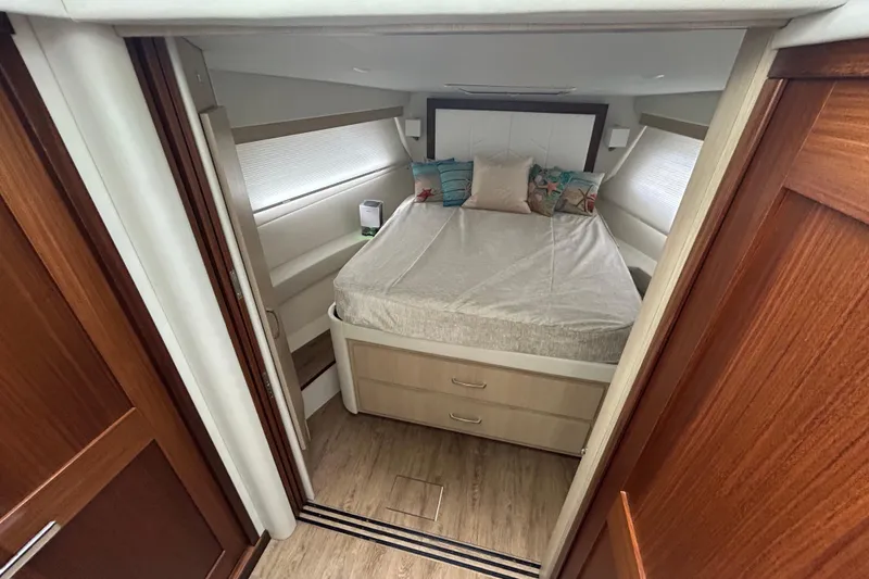 Slide: The Image of Luxurious cabin interior of 2023 Regal 38 FXO yacht with cozy bed and elegant decor. - 94