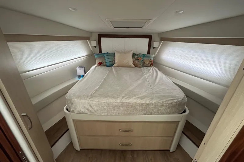 Slide: The Image of Luxurious 2023 Regal 38 FXO yacht bedroom with cozy bed and modern decor. - 95