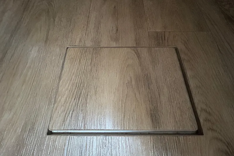 Slide: The Image of Wooden floor panel on a 2023 Regal 38 FXO boat interior. - 97