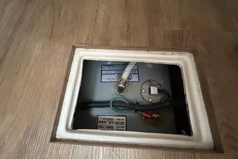 Slide: The Image of Access panel on 2023 Regal 38 FXO boat, revealing internal components and wiring. - 98