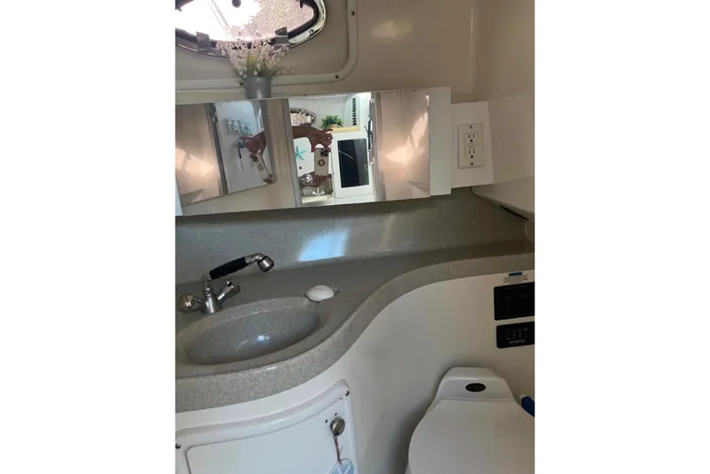 Slide: The Image of 2001 Wellcraft 290 Coastal boat with dual outboard motors on a trailer. - 10