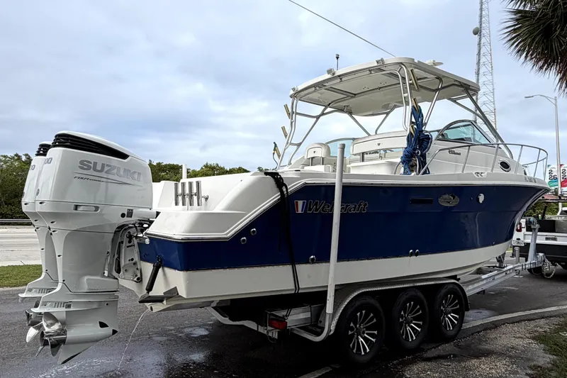 Slide: The Image of 2001 Wellcraft 290 Coastal boat on trailer with Suzuki outboard motor. - 14