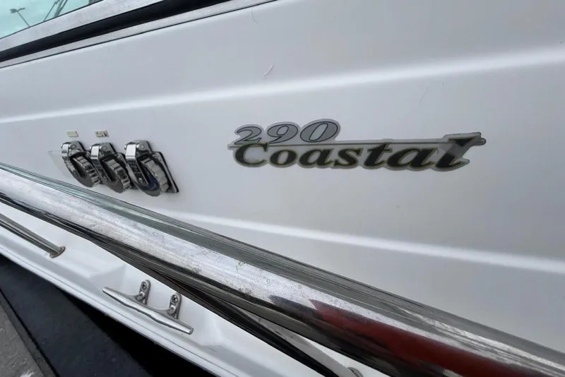 Slide: The Image of 2001 Wellcraft 290 Coastal boat emblem and chrome details. - 23