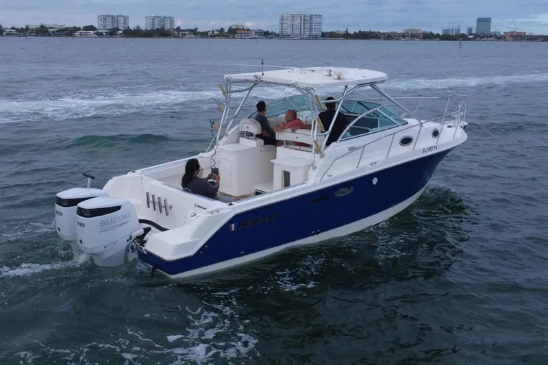 Slide: The Image of 2001 Wellcraft 290 Coastal boat on the water. - 26