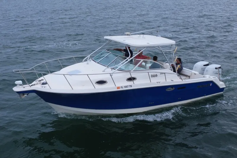 Slide: The Image of 2001 Wellcraft 290 Coastal boat cruising on open water with passengers onboard. - 27