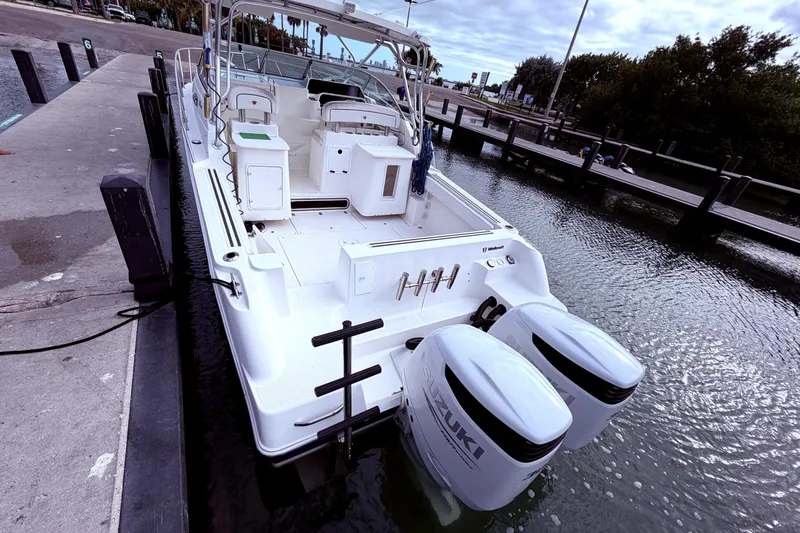Slide: The Image of 2001 Wellcraft 290 Coastal boat docked with twin Suzuki outboard engines. - 28