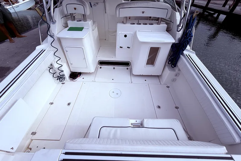 Slide: The Image of 2001 Wellcraft 290 Coastal boat interior with white seating and storage compartments. - 29