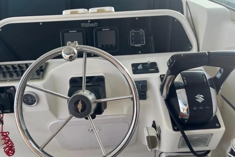 Slide: The Image of 2001 Wellcraft 290 Coastal boat on trailer, parked near palm trees. - 3