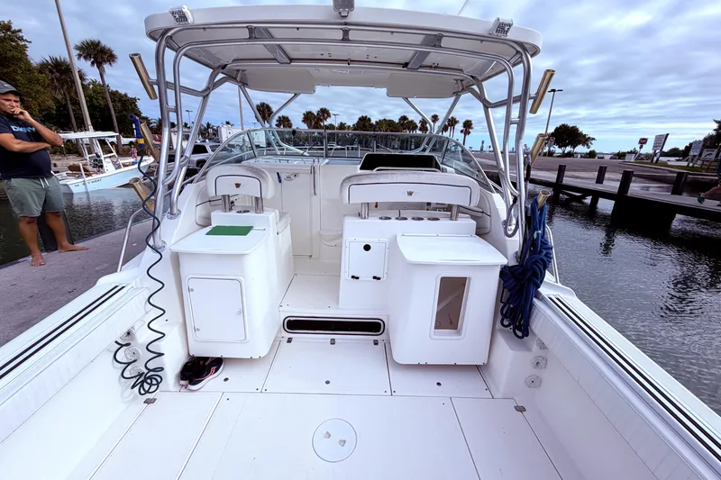 Slide: The Image of 2001 Wellcraft 290 Coastal boat interior with seating and storage, docked by the water. - 30