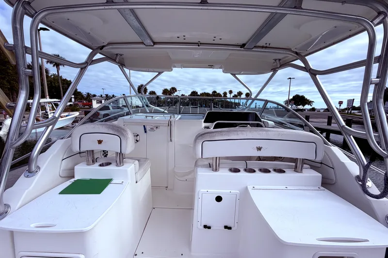 Slide: The Image of 2001 Wellcraft 290 Coastal boat interior with seating and helm, docked at marina. - 33