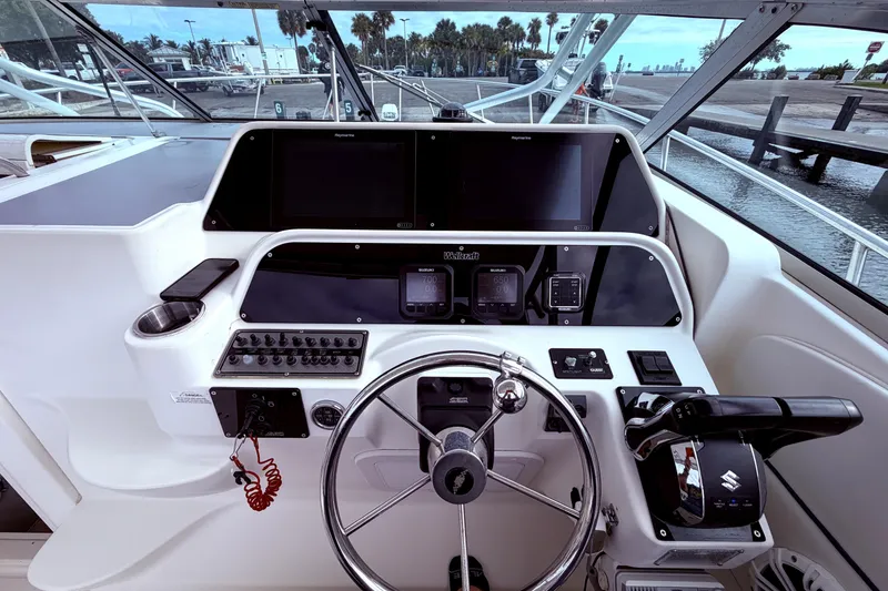 Slide: The Image of 2001 Wellcraft 290 Coastal boat helm with steering wheel and control panel. - 36
