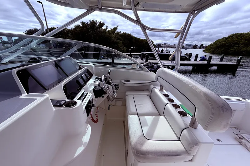 Slide: The Image of 2001 Wellcraft 290 Coastal boat interior with helm, seating, and water view. - 38