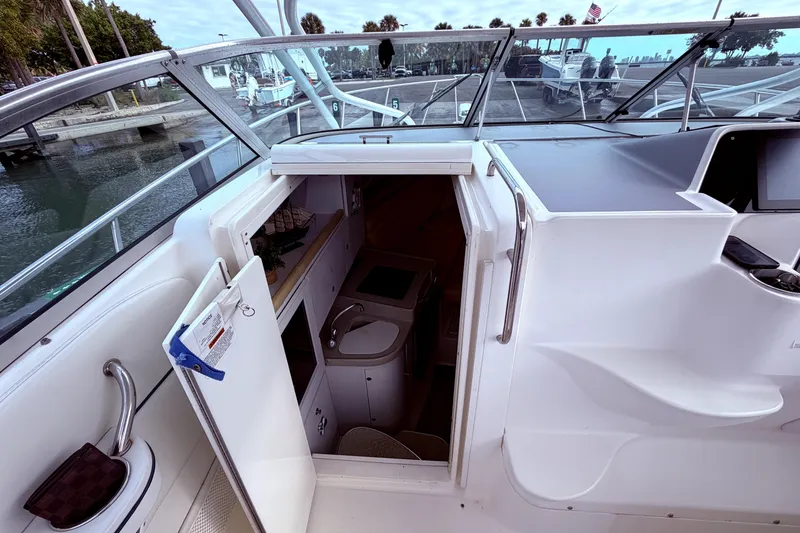 Slide: The Image of 2001 Wellcraft 290 Coastal boat interior with open cabin door, docked at marina. - 40