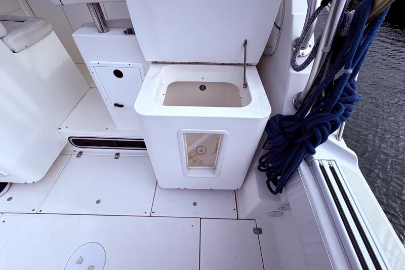 Slide: The Image of 2001 Wellcraft 290 Coastal boat interior with storage compartment and coiled rope. - 41