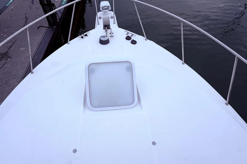 Slide: The Image of Bow of 2001 Wellcraft 290 Coastal boat docked by the water. - 46